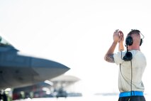 Senior Airman Cameron, 380th Air Expeditionary Wing F-22 Raptor Maintainer, marshals an F-22 Raptor at an undisclosed location in Southwest Asia, Nov. 14, 2016. Cameron was a part of the team that launched Brig. Gen. Charles Corcoran – who reached 1000 successful flying hours as an F-22 pilot – on Veterans Day, 2016. The F-22s in support of Operation Inherent Resolve have participated in approximately 10% of all deliberate strikes in to the dismantling of Da’esh in Mosul, Iraq. (U.S. Air Force photo by Senior Airman Tyler Woodward)