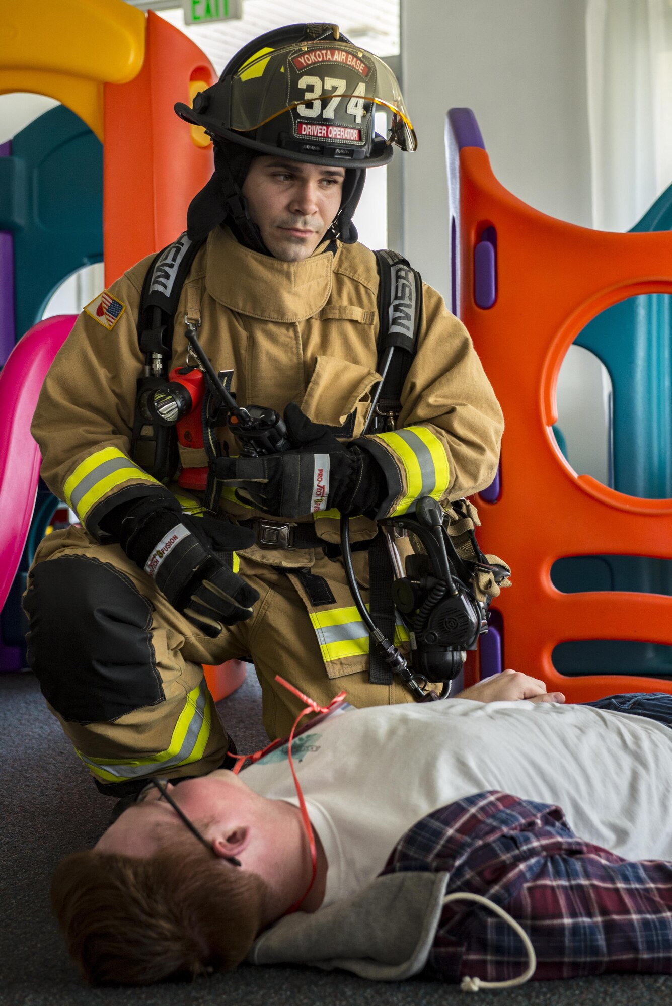A Firefighter from the 374th Civil Engineer Squadron radios in the location and condition of a victim in a simulated building collapse during a natural disaster exercise on Nov. 15, 2016, at Yokota Air Base, Japan. The exercise simulated the coordination of efforts between the U.S. and Japan Self-Defense Force after a natural disaster in the Tokyo metropolitan area. (U.S. photo by Airman 1st Class Donald Hudson/Released)