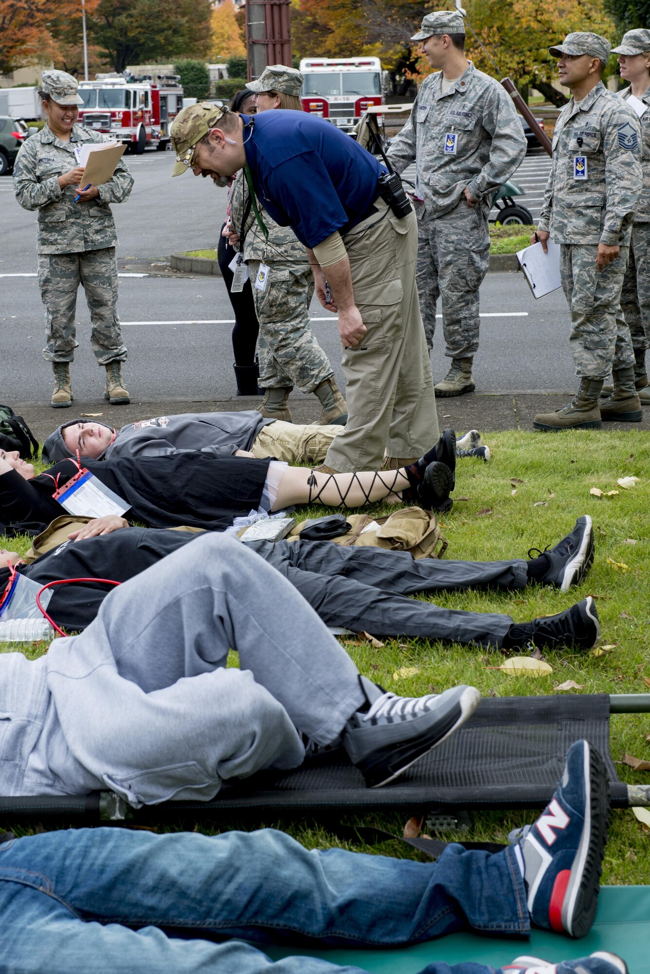 Donald Hoobler, 374th Airlift Wing Plans and Programs deputy chief, checks on simulated victims during a natural disaster exercise on Nov. 15, 2016, at Yokota Air Base, Japan. The exercise simulated a large scale earthquake in the Tokyo metropolitan area and the effects it would have on base operations. (U.S. photo by Airman 1st Class Donald Hudson/Released)