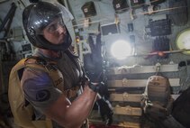 U.S. Air Force Master Sgt. Maurice Muro, 31st Rescue Squadron operations superintendent, signals pararescuemen of the time left until a jump during Exercise Keen Sword 17 Nov. 10, 2016, off the coast of Okinawa, Japan. Rescue teams from the 17th Special Operations Squadron and Japan Air Self Defense Force combined their efforts while participating in a mass casualty exercise during Keen Sword. (U.S. Air Force photo by Senior Airman Lynette M. Rolen/Released)