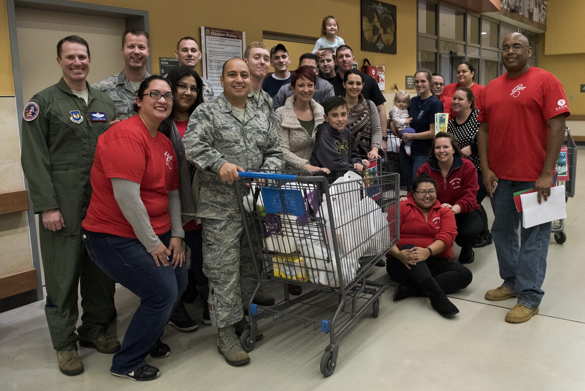 Members of Spangdahlem pose during the Spangdahlem Spouses and Enlisted Members Club Commissary Sweep at Spangdahlem Air Base, Germany, Nov. 15, 2016. Leadership and Commissary customers watched as contestants guessed food item prices, answered riddles and shopped against the clock, without exceeding their given allowance, to win Commissary groceries and gift cards. (U.S. Air Force photo by Airman 1st Class Preston Cherry)