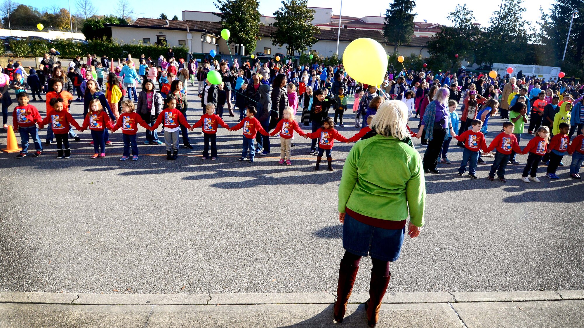 Aviano Elementary School students and faculty prepare for a choreographed dance during a World Kindness Day celebration at Aviano Air Base, Italy on Nov. 15, 2016. More than 600 students and faculty, performed the dance to promote kindness. (U.S. Air Force photo by Senior Airman Areca T. Bell)