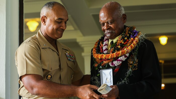 U.S. Marine Corps Brig. Gen. Brian W. Cavanaugh, deputy commander of U.S. Marine Corps Forces, Pacific, presents the Congressional Gold Medal to Dr. Ernest James Harris, Jr. in Honolulu Nov. 12, 2016. Harris was awarded his Congressional Gold Medal for his service as a Montford Point Marine. 