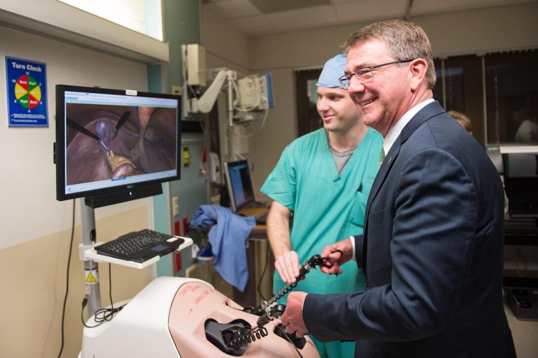 Defense Secretary Ash Carter uses simulated medical training aids during a visit to Brooke Army Medical Center, Fort Sam Houston, Texas.