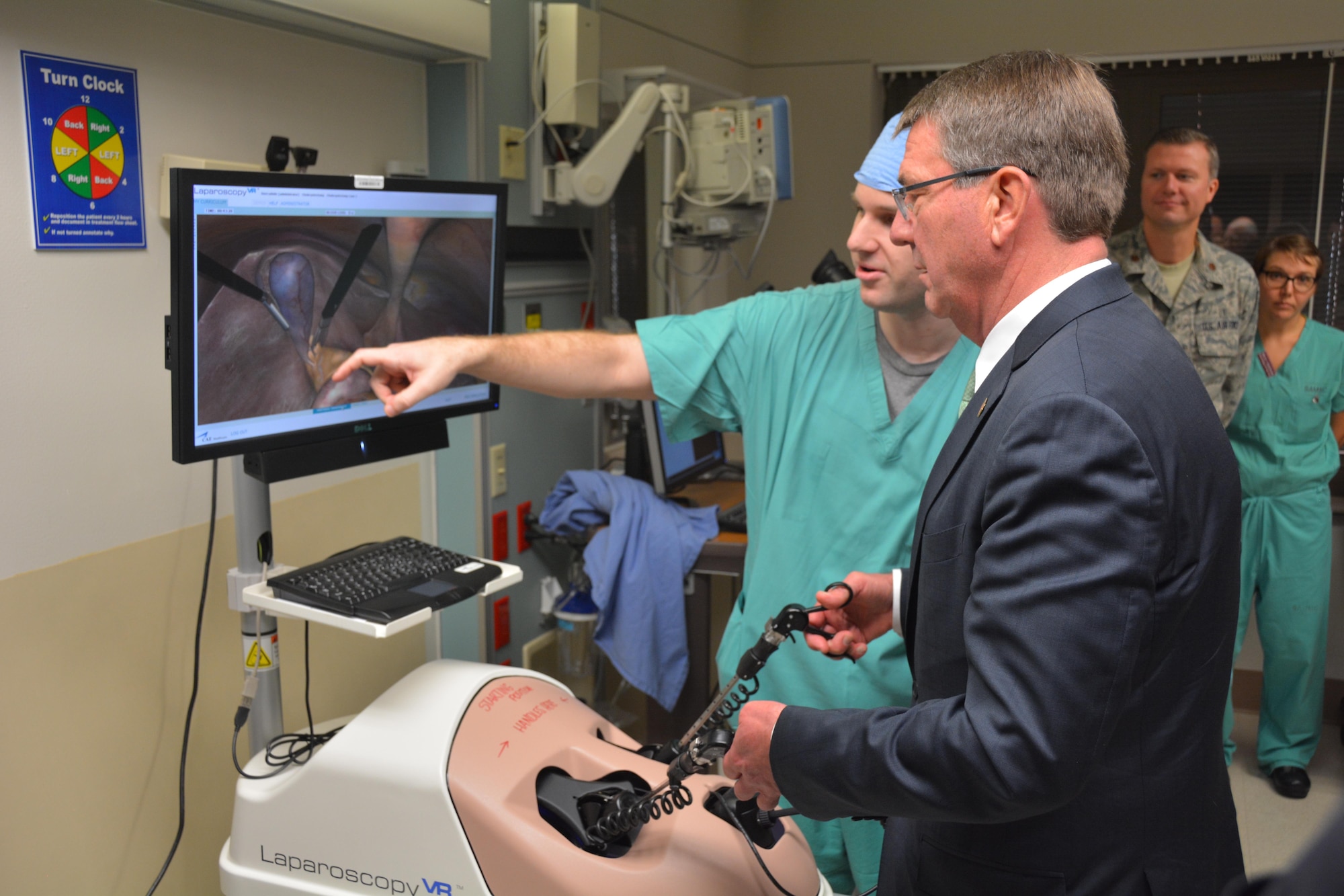 Secretary of Defense Ash Carter steadies his hand using the Laparoscopy simulator under the trained eyes of U.S. Army Maj. John Ritchie during his November 16 visit to Brooke Army Medical Center, Fort Sam Houston, Texas. BAMC is the Army’s largest and busiest medical center. Secretary Carter personally thanked wounded and ill warriors, their families and BAMC staff for their service and sacrifice. Secretary Carter toured labs and simulation centers pioneering new advances in diagnostic imaging and new medical training aids. His visit at BAMC was part of a tour of Joint Base San Antonio, with stops at JBSA-Lackland and JBSA-Randolph. (U.S. Army photo by Robert Shields/Released)