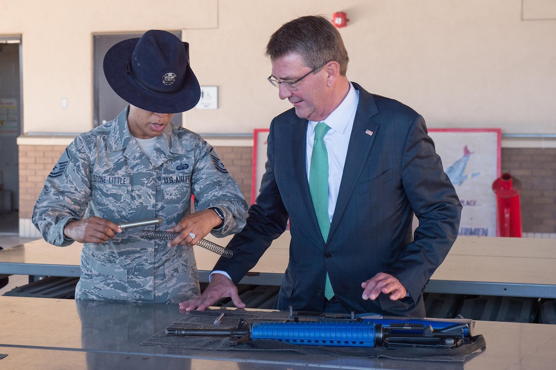 Defense Secretary Ash Carter assembles an M16 rifle during a visit to Joint Base San Antonio-Lackland, Texas.