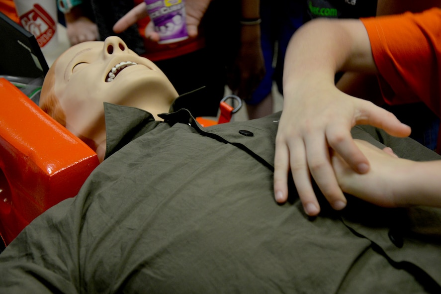 A child learns to performs chest compressions on a SimMan during the 13th Annual Region 15 Robotics Competition at Angelo State University in San Angelo, Texas, Nov. 7, 2016.  The SimMan is is capable of simulating a pulse, breathing and CPR. (U.S. Air Force photo by Airman 1st Class Randall Moose/Released)