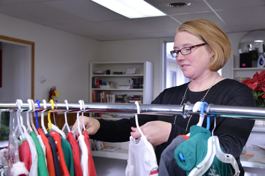 Elizabeth Kasayka, Malmstrom Thrift Store chairman, sifts through clothing at the thrift store Nov. 15, 2016, at Malmstrom Air Force Base, Mont. The proceeds from the store’s sales go toward scholarships for Airmen and their families. (U.S. Air Force photo/Airman 1st Class Daniel Brosam)