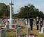 Brig. Gen. Christopher A. Coffelt, commandant, Air War College, salutes facing the Cross of Sacrifice with French Air Force Lieutenant Colonel Fabrice Imbo and RAF Group Captain Paul Taylor Nov. 13, 2016, at Oakwood Cemetery, Montgomery Alabama.  In the cemetery are buried 78 British and 20 French Airmen killed in training accidents in the Southeast U.S. from June 1941 to November 1945. (Photo courtesy of Dr. Robert Kane, Air University Director of History)