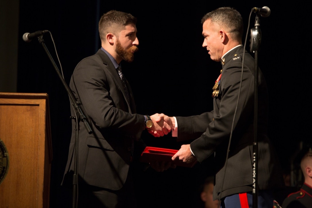 Colonel Morgan G. Mann (right), deputy commander for 25th Marine Regiment, 4th Marine Division, presents Nicholas Rizzo (left), constituent services aide for the office of the Governor and Lieutenant Governor, Common Wealth of Massachusetts, with certificates for his outstanding support of the Marine Corps Reserve Centennial Commemoration at Plymouth Memorial Hall, Nov. 11, 2016. During his remarks, Rizzo declared that Nov. 13-19 will be known as Marine Corps Reserve Week to represent the long standing bond that the state of Massachusetts has with the Marine Corps Reserve. (U.S. Marine Corps photo by Cpl. Melissa Martens/ Released) Martens/ Released)