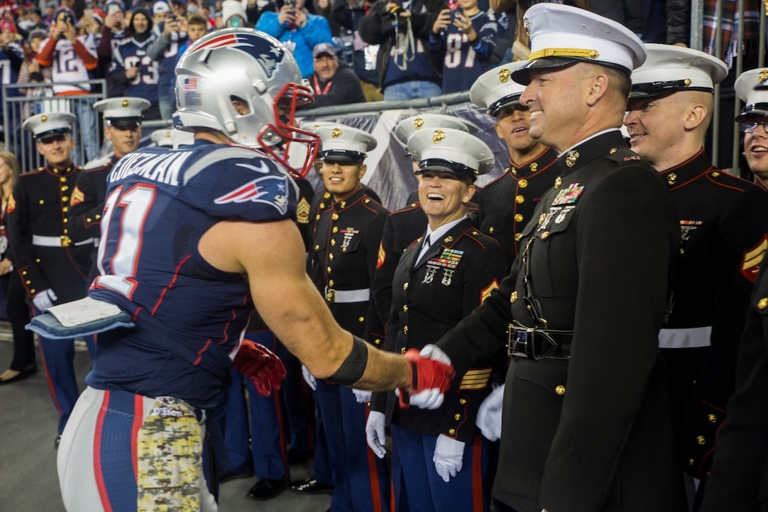 Julian Edelman, wide receiver for the New England Patriots, shakes the hands of Marines from Marine Corps Band New Orleans before the start of the game against the Seattle Seahawks at Gillette Stadium, Nov. 13, 2016. The National Football League recognized service members before and during the game as part of their “Salute to Service” campaign. The band performed a Centennial themed concert as part of the half-time show to commemorate the 100th anniversary of the Marine Corps Reserve. (U.S. Marine Corps photo by Cpl. Melissa Martens/ Released) 
 
