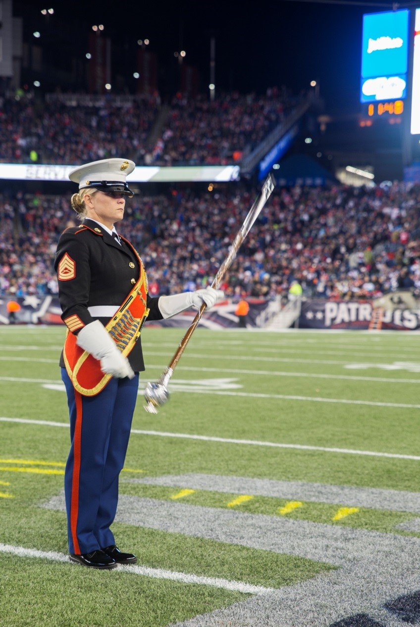 Drum major Gunnery Sgt. Stacie D. Crowther, Marine Corps Band New Orleans, spins the Mace in preparation to march the band into position for their half-time performance during the New England Patriots game against the Seattle Seahawks at Gillette Stadium, Nov. 13, 2016. The band performed a Centennial concert to commemorate the 100th anniversary of the Marine Corps Reserve. From World War I through the wars in Iraq and Afghanistan, the Marine Corps Reserve has played an essential role in the Marine Corps Total Force by augmenting and reinforcing the active component across the full range of military operations. (U.S. Marine Corps photo by Cpl. Melissa Martens/ Released) 
 
