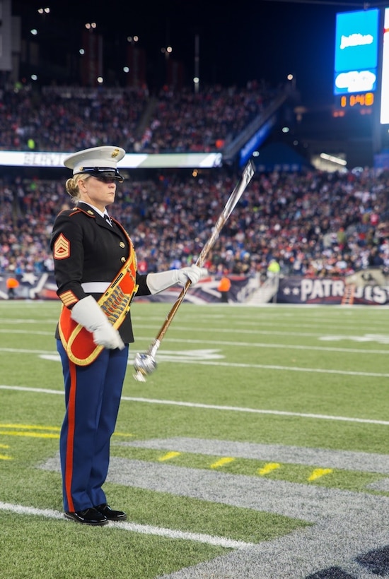 Drum major Gunnery Sgt. Stacie D. Crowther, Marine Corps Band New Orleans, spins the Mace in preparation to march the band into position for their half-time performance during the New England Patriots game against the Seattle Seahawks at Gillette Stadium, Nov. 13, 2016. The band performed a Centennial concert to commemorate the 100th anniversary of the Marine Corps Reserve. From World War I through the wars in Iraq and Afghanistan, the Marine Corps Reserve has played an essential role in the Marine Corps Total Force by augmenting and reinforcing the active component across the full range of military operations. (U.S. Marine Corps photo by Cpl. Melissa Martens/ Released) 
 
