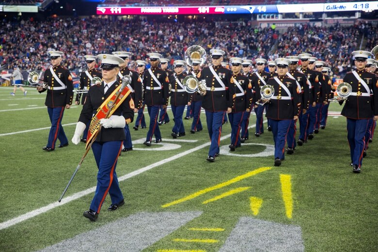 Gunnery Sgt. Stacie D. Crowther, drum major for Marine Corps Band New Orleans, leads the band off the field after their half-time performance at the New England Patriots game against the Seattle Seahawks at Gillette Stadium, Nov. 13, 2016. The band performed a Centennial concert to commemorate the 100th anniversary of the Marine Corps Reserve. From World War I through the wars in Iraq and Afghanistan, the Marine Corps Reserve has played an essential role in the Marine Corps Total Force by augmenting and reinforcing the active component across the full range of military operations. (U.S. Marine Corps photo by Cpl. Melissa Martens/ Released) 
