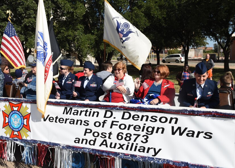 Dyess Airmen and veterans from the Martin D. Henson Veterans of Foreign Wars Post 6873 ride on a float during the 2016 Veterans Day Parade in Abilene, Texas, Nov. 12, 2016. This year’s theme was, “A Salute to Women in Service,” honoring the sacrifices military women have made since the Revolutionary War. (U.S. Air Force photo by Senior Airman Kedesha Pennant)