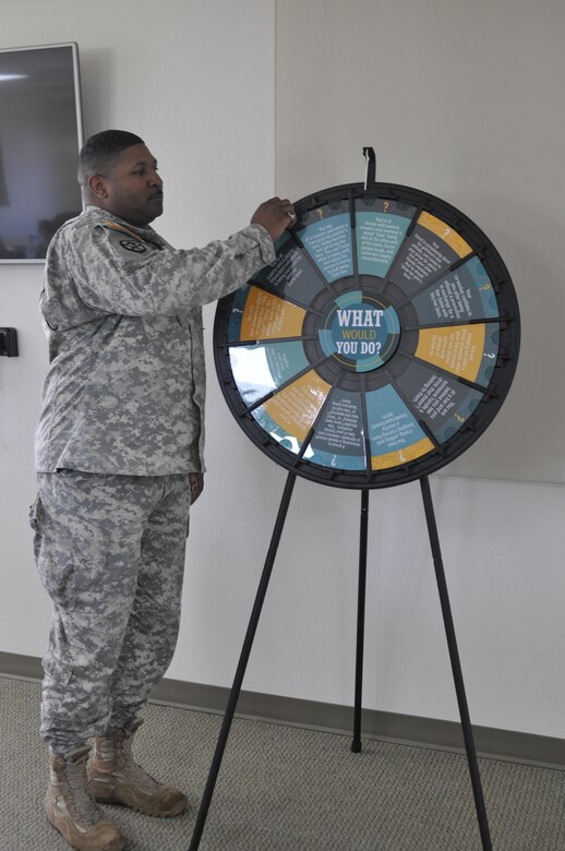 Sgt. 1st Class James Glass, senior supply non-commissioned officer, 351st Civil Affairs Command, spins the ‘what would you do’ wheel to take a chance at solving a Sexual Harassment/Assault Response scenario, Nov. 9, Camp Parks, Dublin, Calif. The wheel was repeatedly used as a creative teaching method to prepare for real occurrences after graduating as Sexual Assault Response Coordinators. (U.S. Army Reserve photo by Sgt. 1st Class LaTonya Kelly)