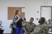 Meg Haycraft (left), director of psychological health, 63rd Regional Support Command, kicks off her presentation with a personal and comical introduction of her career path, Nov. 9, Camp Parks, Dublin, Calif.  Haycraft provided a list of free community counseling and supportive resources to the newly graduated Sexual Assault Response Coordinators. Her speech was part of a 10-day certification course for 35 SHARP coordinators assigned to the command and subordinate units, Oct. 31 - Nov. 10 (U.S. Army Reserve photo by Sgt. 1st Class LaTonya Kelly)