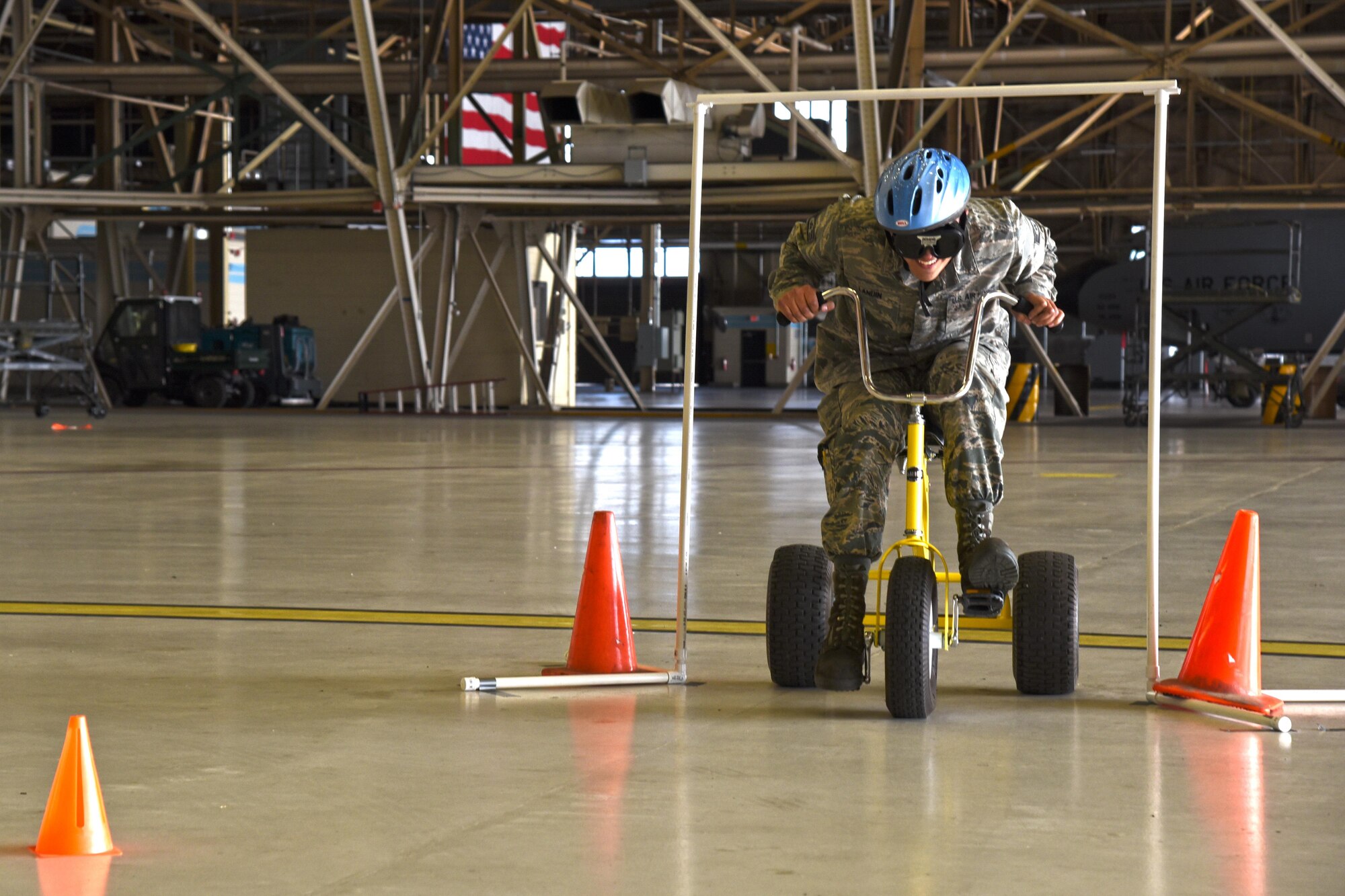 Staff Sgt. Anthony Landin, 92nd Maintenance Squadron aircraft hydraulics system craftsman, participates in the drunken tricycle obstacle course during the 92nd and 141st Maintenance Group Fall Olympics Nov. 15, 2016, at Fairchild Air Force Base. Seven teams participated in four events held throughout the day including circuit building, safety wire challenge, aircraft ground equipment race and a drunken tricycle obstacle course. (U.S. Air Force photo/Airman 1st Class Ryan Lackey)