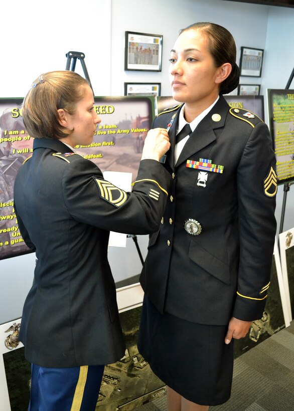 Sgt. 1st Class Cory Luttrell, assigned to the 100th Training Division and an instructor for the 4960th Multi-Functional Training Brigade pilot Army Medical Department Advanced Leader Course Phase II, evaluates the Army Service Uniform of Staff Sgt. Kiley Neves, a student enrolled in the course. The course focused on multiple leadership fundamentals such as the military decision making process, the Army Operating Concept and written communication as well as information related to the 68 series military occupational specialty.