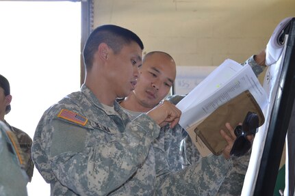 Sgt. Leonardo De Luna, a student attending the 4960th Multi-Functional Training Brigade new pilot Army Medical Department Advanced Leader Course Phase II, explains his part of a training exercise to Staff Sgt. Brandon Maki, another student enrolled in the class. The course was held at Fort Shafter Flats, Hawaii, October 30 - November 12, 2016.