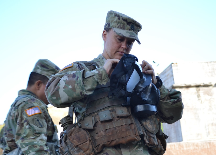 Staff Sgt. Linsey McCray, an active duty Soldier attending the 4960th Multi-Functional Training Brigade (Total Army School System) pilot Army Medical Department Advanced Leader Course Phase II, inspects her mask during a situational training exercise. The course was held at Fort Shafter Flats, Hawaii, October 30 - November 12, 2016.