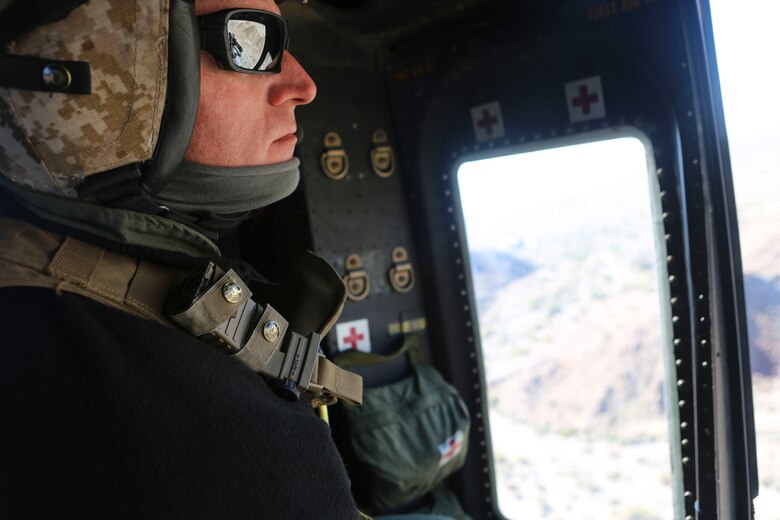 Gunnery Sgt. Christopher Slaven, a crew chief with Marine Light Attack Helicopter Squadron (HMLA) 267 waits for a UH-1Y Huey to reach the simulated targets during exercise Scorpion Fire 1-16 near Navy Air Facility El Centro, Calif. Jan. 25.  HMLA-267 supported the exercise with close air support and live-fire capabilities, Jan. 25 to Feb. 5.