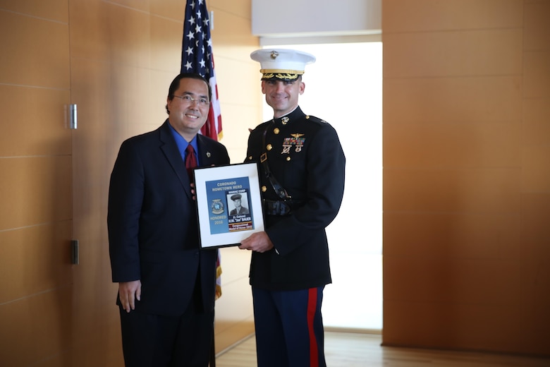 Lt. Col. Tim Cooper, right, executive officer of Marine Aircraft Group (MAG) 11, accepts recognition from Casey Tanaka, Mayor of Coronado, Calif., on behalf of Lt. Col. Harold Bauer, a fallen Marine Corps fighter pilot, during the 4th biannual Hometown Hero Banner event, Nov. 5. The Hometown Hero Banner Program was started in order to honor service members who served gallantly in the past by displaying banners on the Avenue of Heroes.