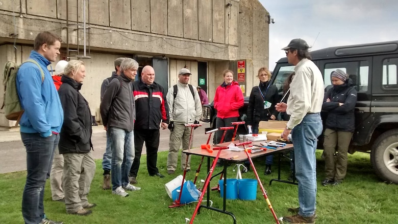 ERDC-CRREL Senior Research Engineer Michael “Mike” Walsh provides instruction on how to sample and how to collect samples before the two-day field exercise at the Cranfield Ordnance Test and Evaluation Centre, Wiltshire, England.