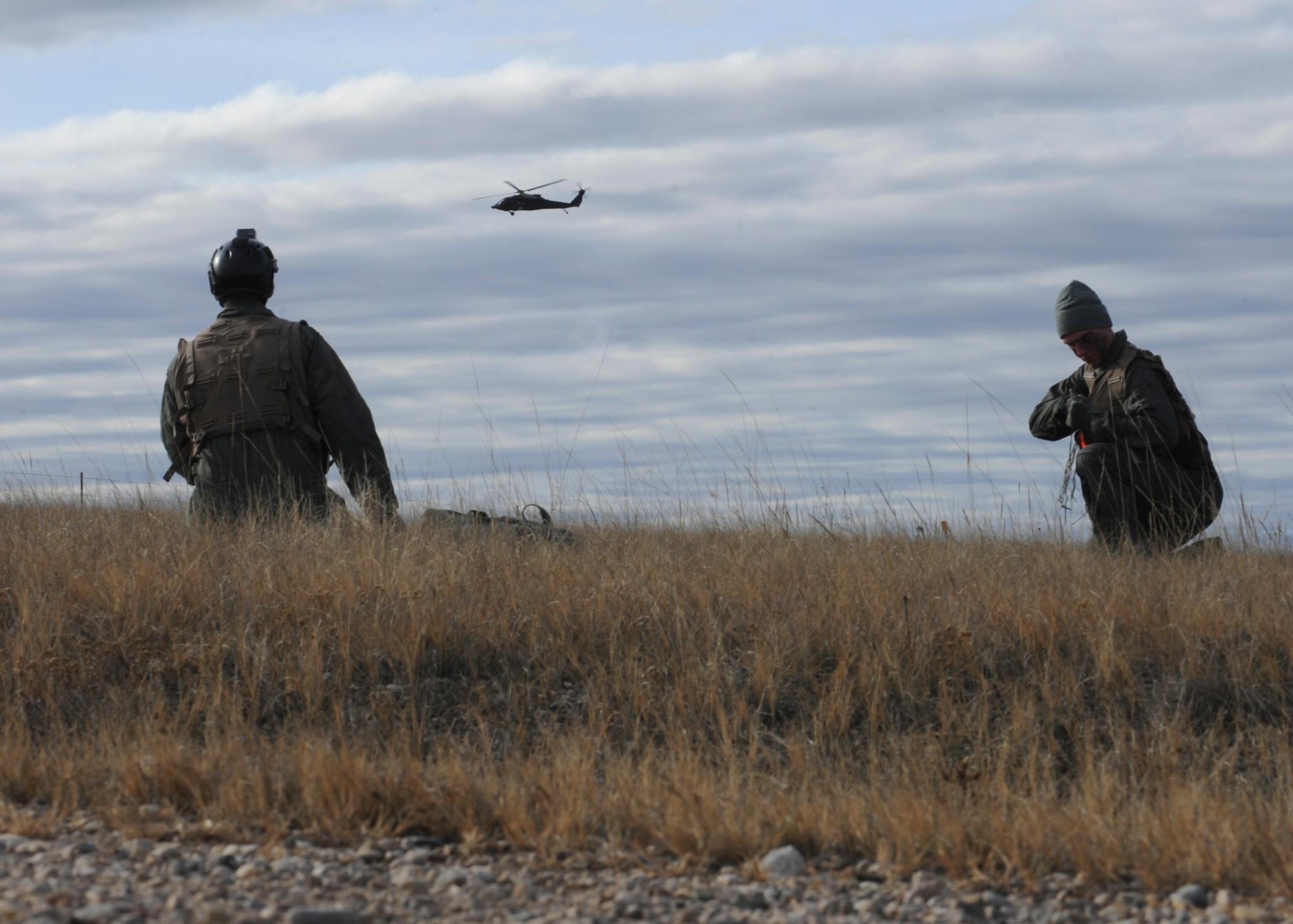 Aviators from the 28th Bomb Wing, await rescue during a joint training exercise at the Powder River Training Complex, Belle Fourche, S.D. Nov. 16, 2016. The training exercise simulated rescuing two injured service members in an urban contested environment. (U.S. Air Force photo by Senior Airman Anania Tekurio/Released)