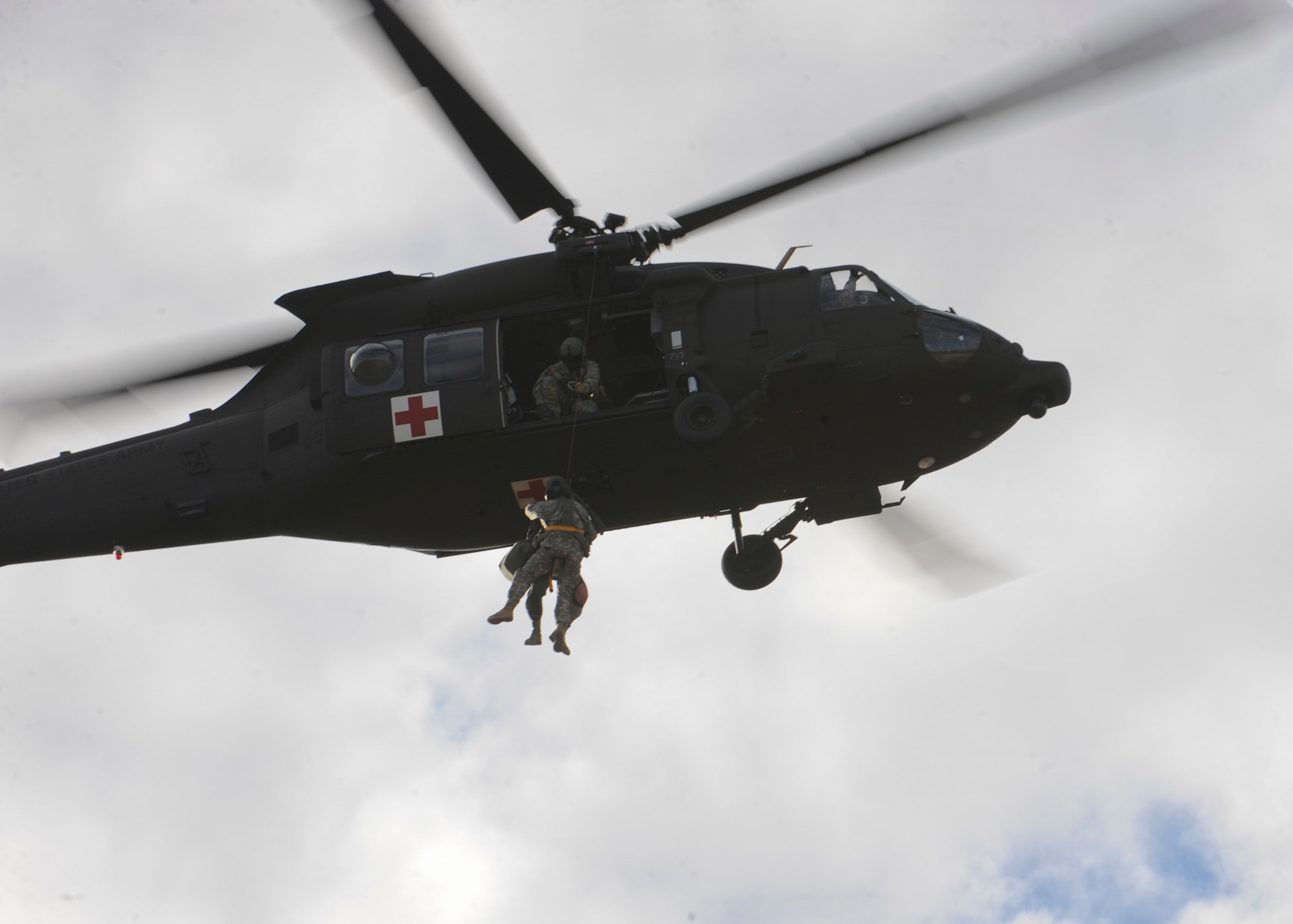 Soldiers from the South Dakota National Guard’s Company C, 1st Battalion, 189th Aviation Regiment, rescue two injured service members during a joint training exercise at the Powder River Training Complex, Belle Fourche, S.D., Nov. 16, 2016. The training exercise was designed to train aircrew under realistic scenarios against modern threats and included fighter, tanker and bomber aircraft from across the U.S. armed forces. (U.S. Air Force photo by Senior Airman Anania Tekurio/Released)