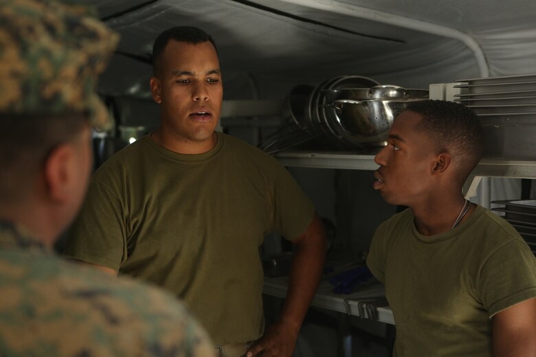 U.S. Marine Lance Cpl. Emmauel Gomezricart and Lance Cpl. Daniel Howell lead medical technicians on a walkthrough of an expeditionary field kitchen during Preventative Medicine Exercise 2016 at Camp Pendleton, Calif., Nov. 10, 2016. The medical technicians inspected for sanitation, operational ability of the equipment and for the presence of vermin. 1st Medical Battalion used this exercise to better prepare their Sailors for deployments and to practice accomplishing an objective in a field environment. Gomezricart and Howell are food service specialists with Food Service Company, Headquarters Regiment, 1st Marine Logistics Group. (U.S. Marine Corps photo by Lance Cpl. Joseph Sorci)