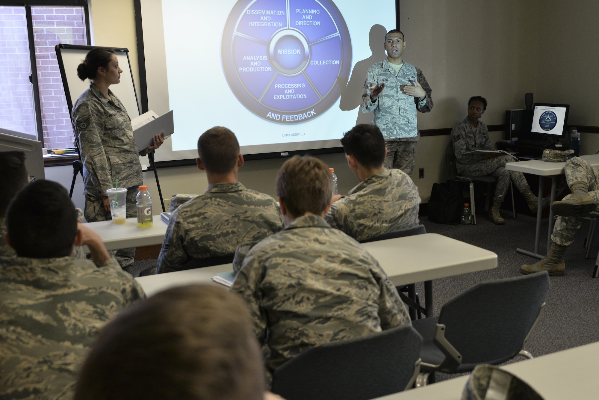 Staff Sgt. Bazil Rivera and David Gunn, 70th Operations Support Squadron, brief intelligence Airmen from the 70th Intelligence, Surveillance and Reconnaissance Wing during their National Tactical Integration training November 4, 2016 at Fort Meade, Md. AF NTI works as an enterprise that collaborates to enhance Air Component operations around the world, as well as leveraging critical nation Intelligence Community information and capabilities. (U.S. Air Force photo/Staff Sgt. Alexandre Montes)

