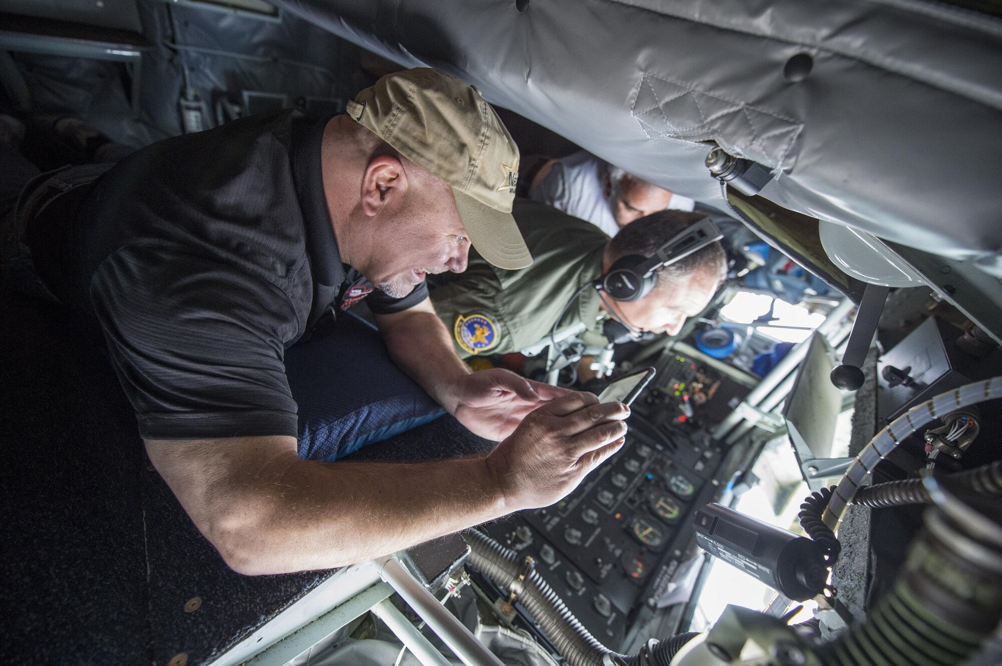 Ken Holtzinger, production manager from Logansport’s Indiana's Best Radio, photographs an air refueling mission from the boom pod of a 434th Air Refueling Wing KC-135R Stratotanker over the Midwest Nov. 16, 2016. The media flight was designed to showcase the Air Force’s mission and foster positive community relations. (U.S. Air Force photo/Tech. Sgt. Benjamin Mota)