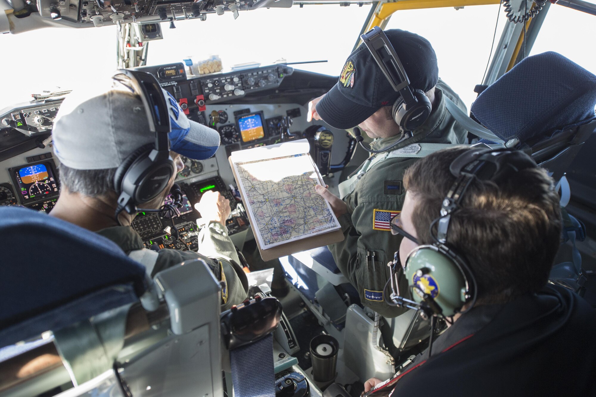 Left, Lt. Col. Brian Hollis, 434th Operations Support commander, and 1st Lt. Erich Maul, 72 Air Refueling Squadron pilot, show Seth Tocco, radio personality from Logansport’s Indiana's Best Radio, their flight path from the cockpit of a 434th Air Refueling Wing KC-135R Stratotanker during a refueling mission over the Midwest Nov. 16, 2016. The mission gave local media the chance to see a refueling mission from start to finish. (U.S. Air Force photo/Tech. Sgt. Benjamin Mota)