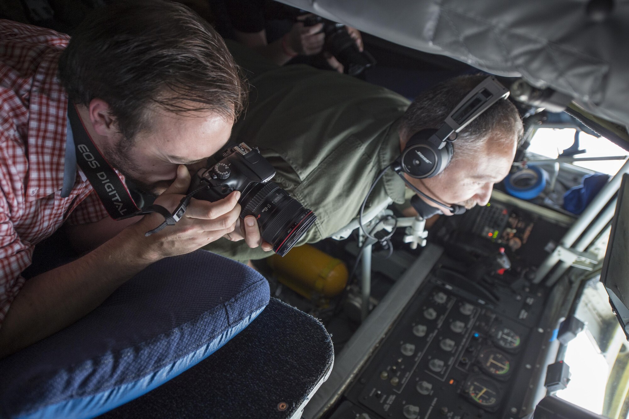 Devin Zimmerman, a journalist from The Kokomo Perspective, photographs an air refueling mission from the boom pod of a 434th Air Refueling Wing KC-135R Stratotanker over the Midwest Nov. 16, 2016. The media flight was designed to showcase the Air Force’s mission and foster positive community relations. (U.S. Air Force photo/Tech. Sgt. Benjamin Mota)