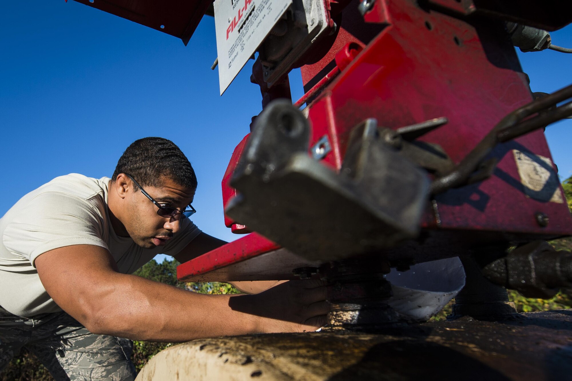 Senior Airman Chris Coney, a water and fuels system specialist with the 1st Special Operations Civil Engineer Squadron, places an absorbent pad under a fuel pump at Hurlburt Field, Fla., Nov. 17, 2016. Absorbent pads are used to control and absorb diesel, fuel, oil and other fluids while repelling water. (U.S. Air Force photo by Airman 1st Class Joseph Pick)
