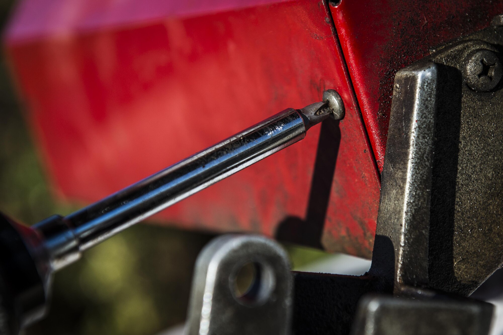 Senior Airman Chris Coney, a water and fuels system specialist with the 1st Special Operations Civil Engineer Squadron, screws the exterior panel of a fuel pump closed at Hurlburt Field, Fla., Nov. 17, 2016. The 1st SOCES replaced a fuel pump with a new one. (U.S. Air Force photo by Airman 1st Class Joseph Pick)