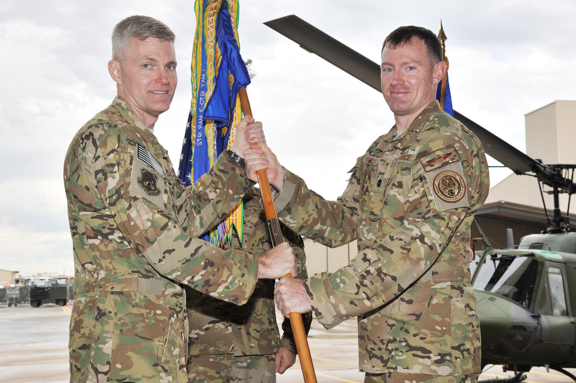 Lt. Col. Joshua Hampton, right, accepts command of the 40th Helicopter Squadron from Col. David Smith, 582nd Helicopter Group commander, June 24 in the squadron’s helicopter hangar at Malmstrom Air Force Base, Mont. Hampton is no stranger to the nuclear deterrence mission and served as the director of operations for the 54th Helicopter Squadron at Minot AFB. (U.S. Air Force photo/John Turner)