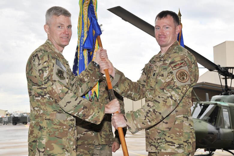 Lt. Col. Joshua Hampton, right, accepts command of the 40th Helicopter Squadron from Col. David Smith, 582nd Helicopter Group commander, June 24 in the squadron’s helicopter hangar at Malmstrom Air Force Base, Mont. Hampton is no stranger to the nuclear deterrence mission and served as the director of operations for the 54th Helicopter Squadron at Minot AFB. (U.S. Air Force photo/John Turner)