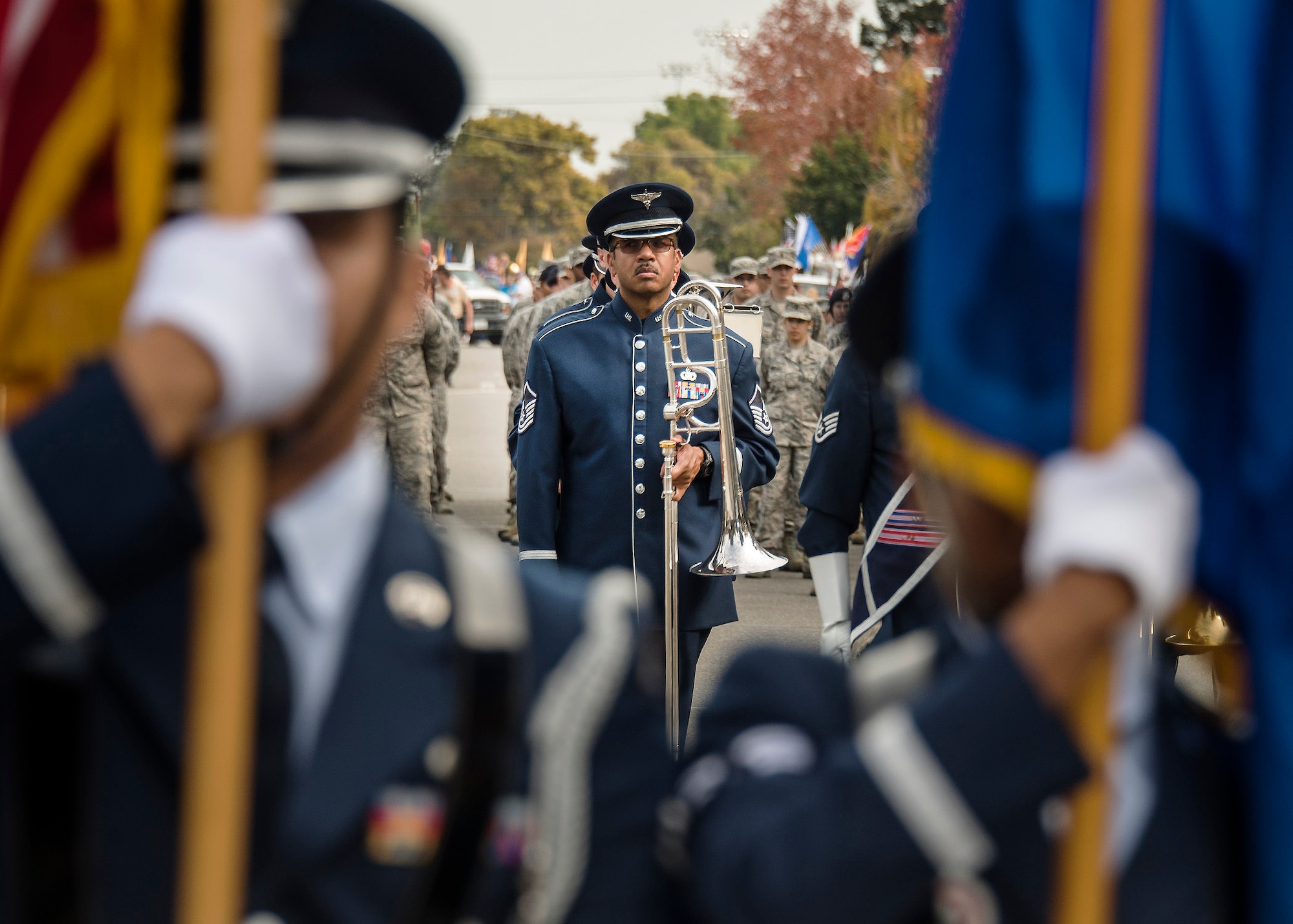 Master Sgt.  Michael Hornbuckle, U.S. Air Force Band of the Golden West, Travis Air Force Base, Calif., stands at attention with his trombone as the band prepares to march through downtown Fairfield Calif.  The city held its Veterans Day Commemoration and Parade celebration in front of over 1,000 cheering spectators.  The Nov. 11, 2016 celebration honoring America’s finest included a formation of Airmen, a C-17 Globemaster III flyover and Col. John Klein Jr., 60th Air Mobility Wing commander, who was the grand marshal of the parade.  (U.S. Air Force Photo by T.C. Perkins Jr.)