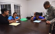 Tech. Sgt. Christopher McShan II, 341st Civil Engineer Squadron emergency management flight section chief, and his wife Myisha, help their sons with homework at their home at Malmstrom Air Force Base, Mont., Nov. 17, 2016. Christopher and Myisha instill in their boys the importance of holding themselves accountable in everything they do. (U.S. Air Force photo/Senior Airman Jaeda Tookes)