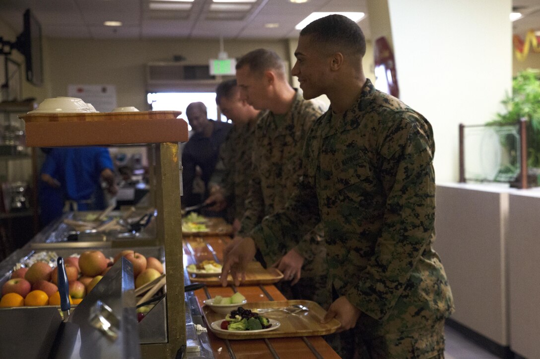 Marines partake of the numerous fresh fruit and vegetable items at the Marine Corps Air Station Futenma mess hall during the 241st Marine Corps Birthday celebration Nov. 9 on Marine Corps Air Station Futenma, Okinawa, Japan. The Marine Corps Birthday is traditionally celebrated with a special meal of steak, lobster and many other courses and is open to Marines, base employees and their families. Marines and master labor contractors assigned to the MCAS Futenma mess hall welcomed Marines, civilian contractors and MLCs to enjoy the delectable courses, a uniform pageant by the Kubasaki High School Junior Reserve Officer Training Corps cadets, and live music by the III Marine Expeditionary Force Band. (U.S. Marine Corps photo by Cpl. Janessa K. Pon / Released)