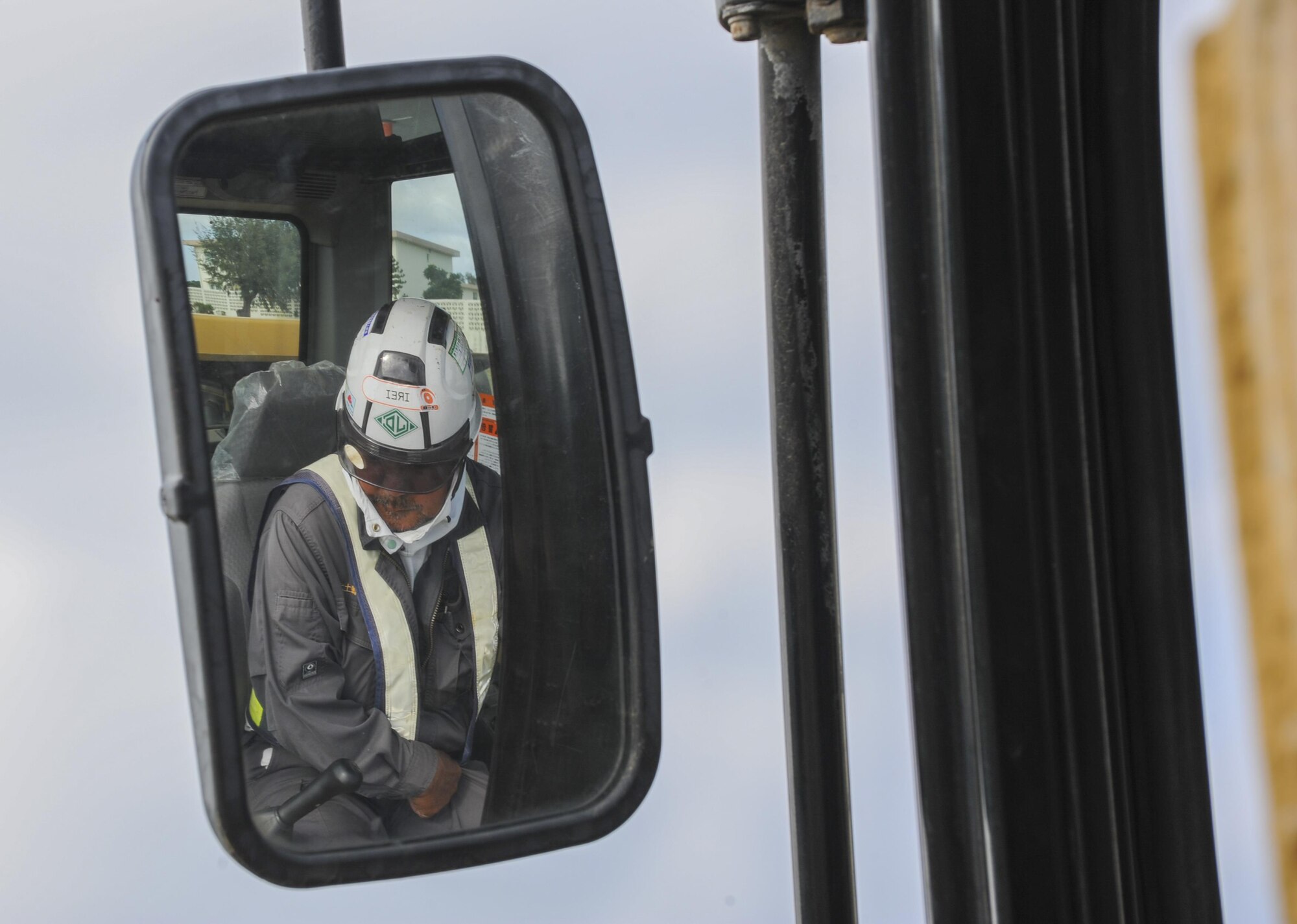 Mineyuki Ikei, an excavator operator with Kochi Construction, operates an excavator, assisting in the replacement of sewer pipes Nov. 16, 2016, at Kadena Air Base, Japan. Japanese contractors are often hired by the 18th Contracting Squadron to support Kadena’s infrastructure as well as to contribute to the Okinawan community. (U.S. Air Force photo by Airman 1st Class Nick Emerick/Released) 