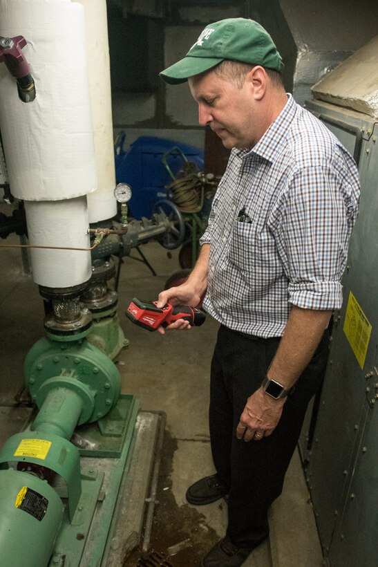 Tom Spalding, base energy manager for the 123rd Airlift Wing, uses a thermal imager to take infrared pictures of equipment at the Kentucky Air National Guard Base in Louisville, Ky., Sept. 25, 2016. Equipment that runs abnormally hot can indicate failing parts and increased energy consumption. (U.S. Air National Guard photo by Master Sgt. Phil Speck)