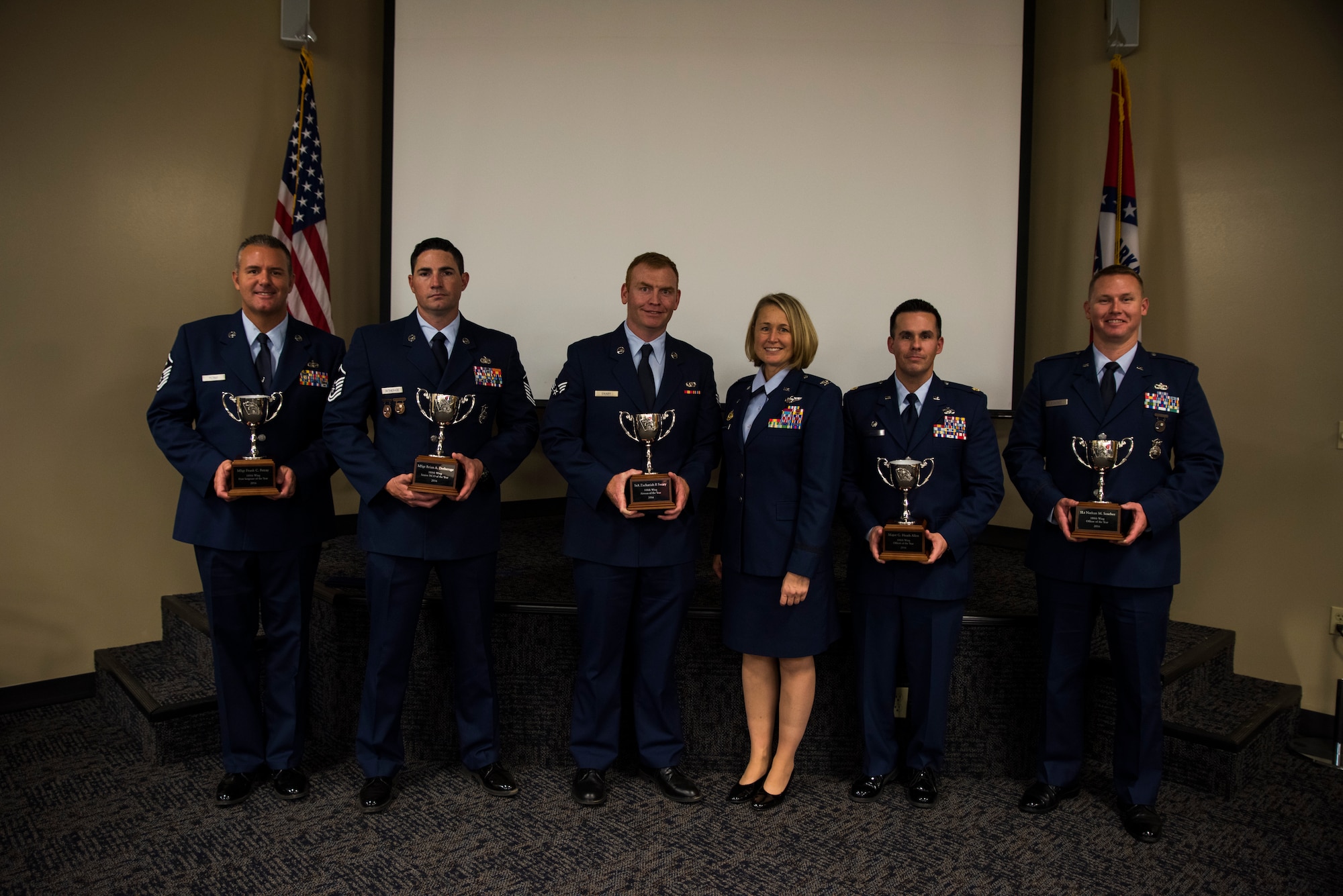 The Outstanding Airman of the Year winners present their trophies beside Col. Bobbi Doorenbos, 188th Wing commander, Nov. 5, 2016, at Ebbing Air National Guard Base, Fort Smith, Ark. The Outstanding Airman of the Year program promotes professional development, innovation and mission success by recognizing those who excel in their carrier fields while fostering the cultivation of ready, responsive and highly-skilled Airman. (U.S. Air National Guard photo by Senior Airman Cody Martin)