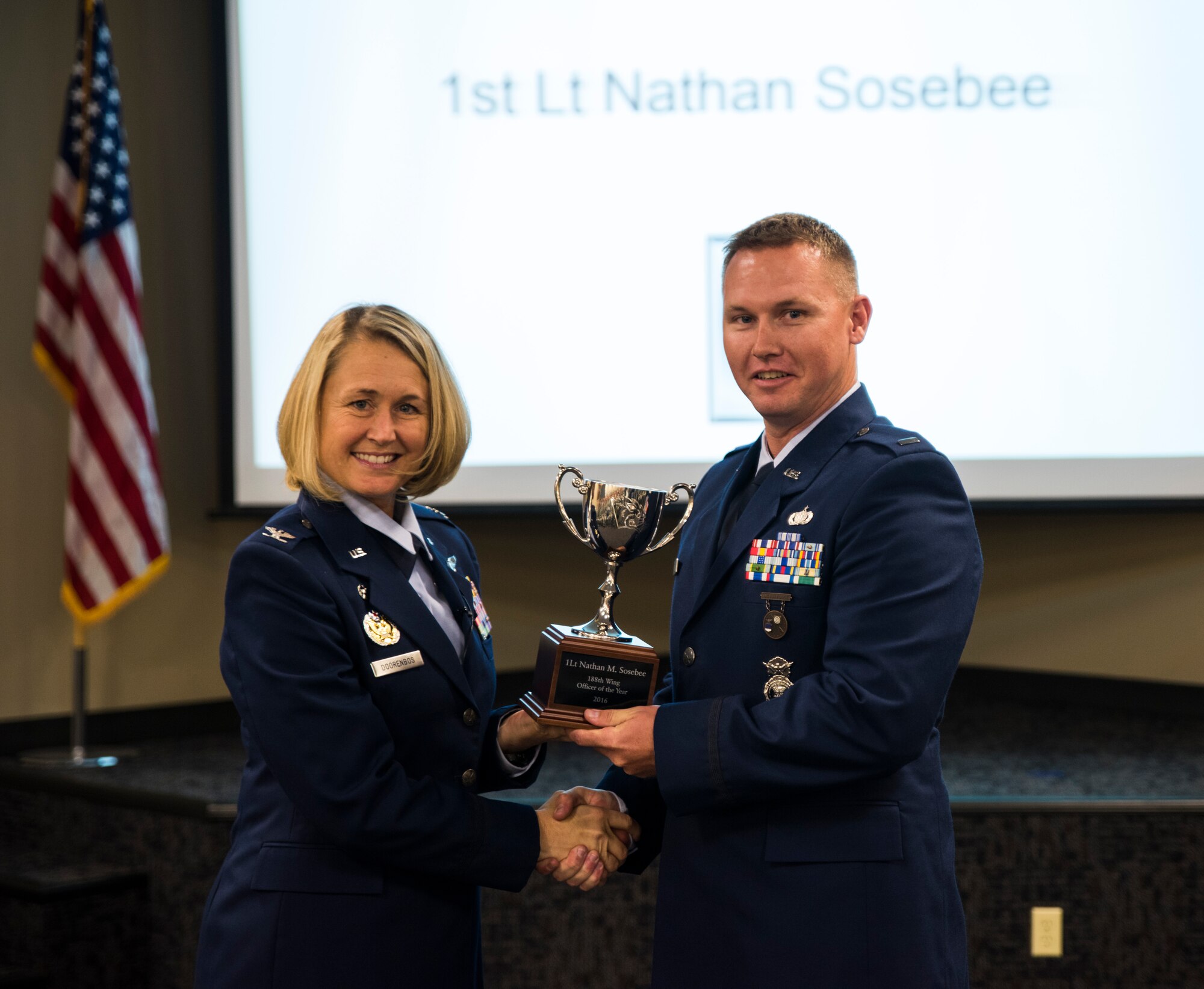 1st Lt. Nathan Sosebee, 188th Security Forces Squadron, is awarded the 2016 Company Grade Officer of the Year Nov. 5, 2016, at Ebbing Air National Guard Base, Fort Smith, Ark. The Outstanding Airman of the Year program promotes professional development, innovation and mission success by recognizing those who excel in their carrier fields while fostering the cultivation of ready, responsive and highly-skilled Airman. The award was presented to Sosebee by Col. Bobbi Doorenbos, 188th Wing commander. (U.S. Air National Guard photo by Senior Airman Cody Martin)