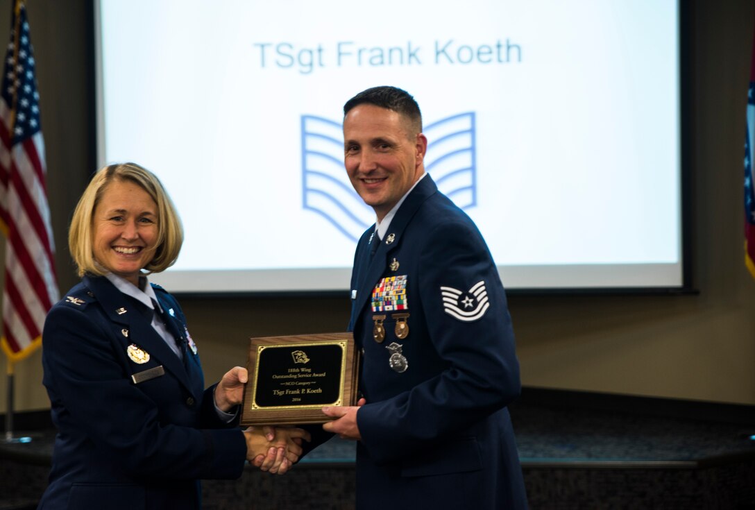 Tech. Sgt. Frank Koeth, 188th Security Forces Squadron, is awarded the 2016 Outstanding Service award, noncommissioned officer category, Nov. 5, 2016, at Ebbing Air National Guard Base, Fort Smith, Ark. The Outstanding Airman of the Year program promotes professional development, innovation and mission success by recognizing those who excel in their carrier fields while fostering the cultivation of ready, responsive and highly-skilled Airman. The award was presented to Koeth by Col. Bobbi Doorenbos, 188th Wing commander. (U.S. Air National Guard photo by Senior Airman Cody Martin)