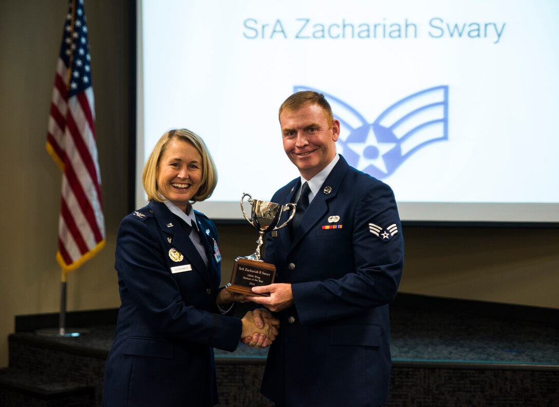 Senior Airman Zachariah Swary, 188th Operations Support Squadron, is awarded the 2016 Outstanding Airman of the Year award Nov. 5, 2016, at Ebbing Air National Guard Base, Fort Smith, Ark. The Outstanding Airman of the Year program promotes professional development, innovation and mission success by recognizing those who excel in their carrier fields while fostering the cultivation of ready, responsive and highly-skilled Airman. The award was presented to Swary by Col. Bobbi Doorenbos, 188th Wing commander. (U.S. Air National Guard photo by Senior Airman Cody Martin)