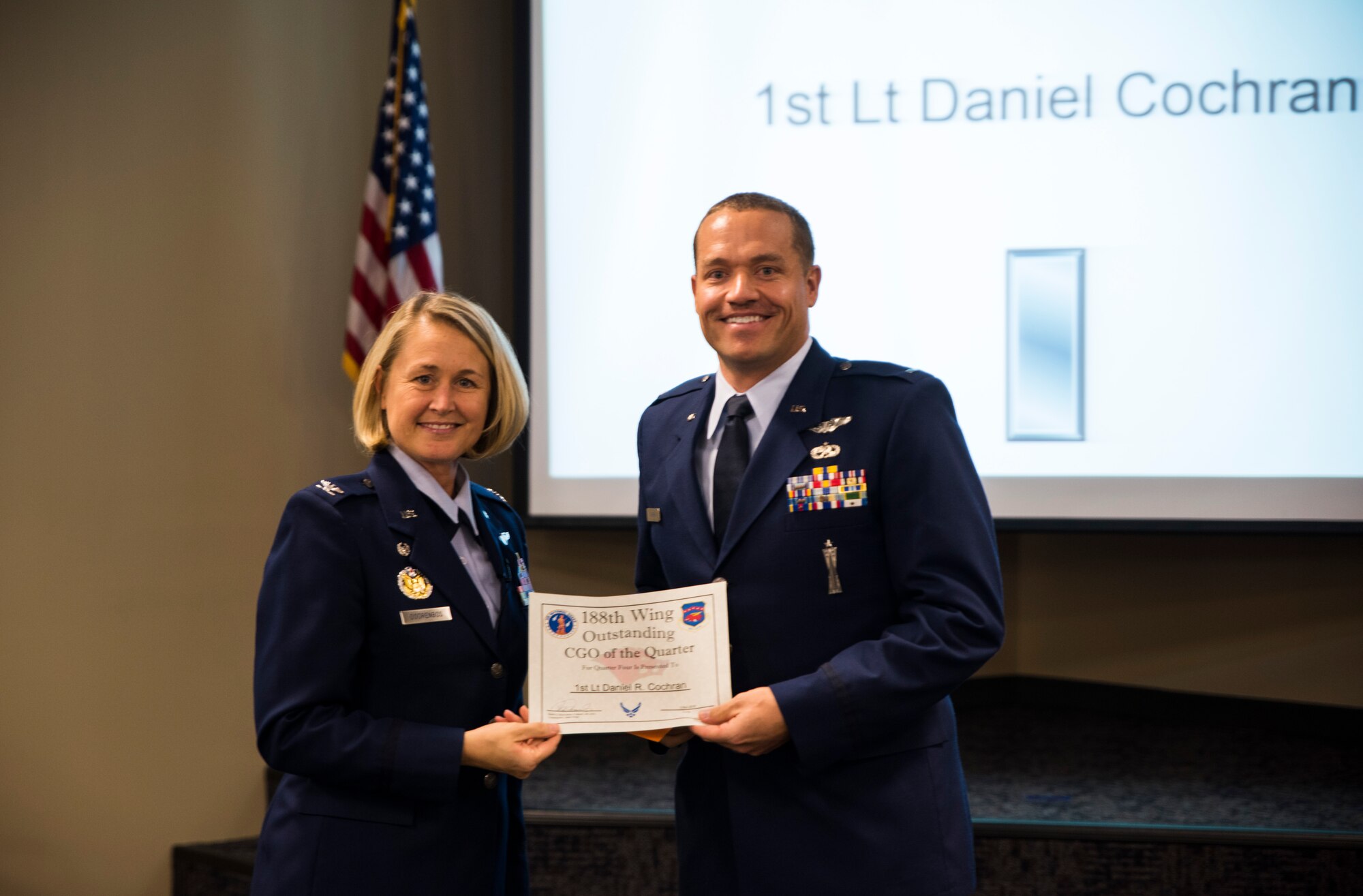 1st Lt. Daniel Cochran, 184th Attack Squadron, is awarded the Outstanding Company Grade Officer of the Quarter award Nov. 5, 2016, for the final quarter of fiscal year 2016 at Ebbing Air National Guard Base, Fort Smith, Ark. The Outstanding Airman of the Quarter program promotes professional development, innovation and mission success by recognizing those who excel in their carrier fields while fostering the cultivation of ready, responsive and highly-skilled Airman. The award was presented to Cochran by Col. Bobbi Doorenbos, 188th Wing commander. (U.S. Air National Guard photo by Senior Airman Cody Martin)