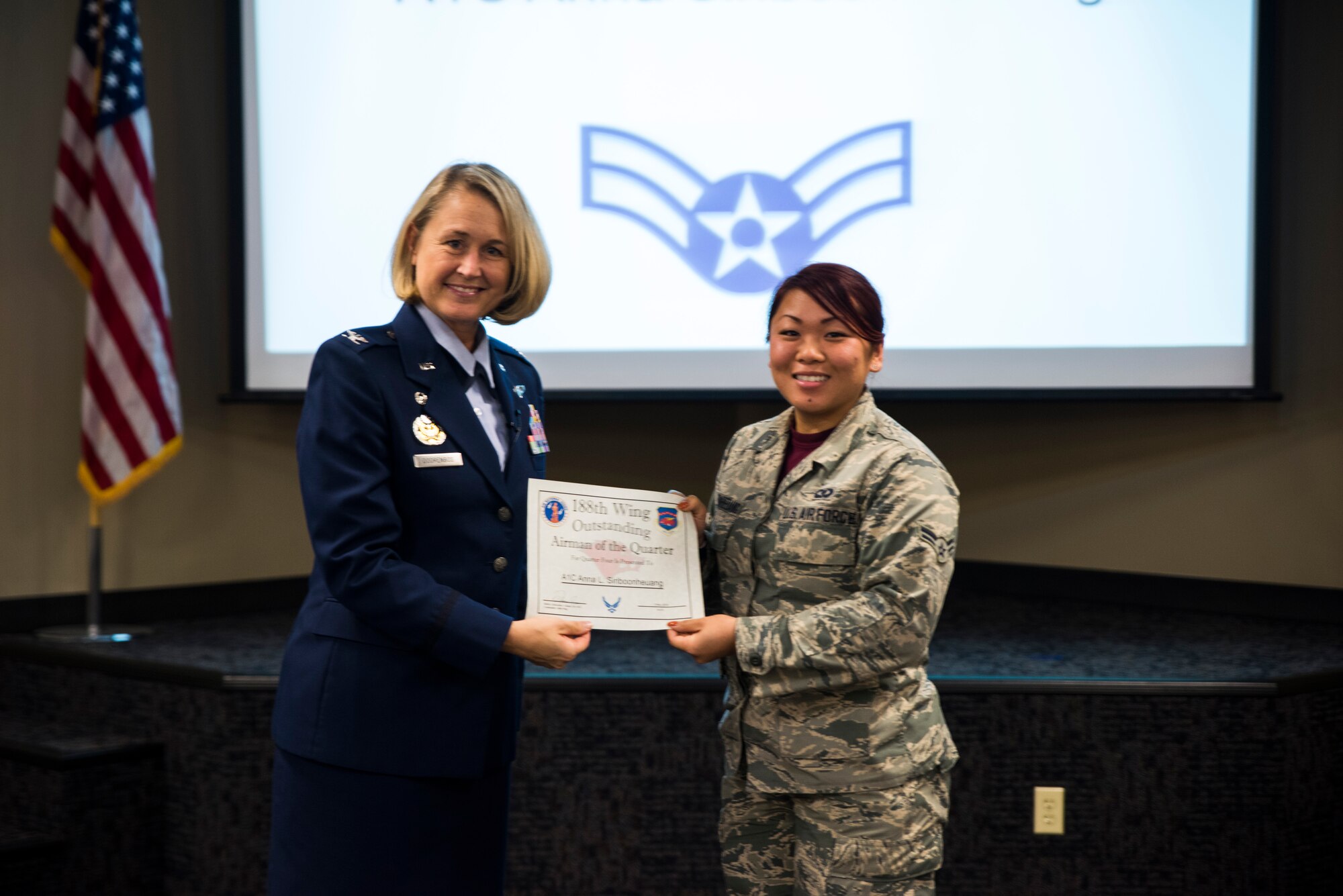 Senior Airman Anna Siriboonheuang, 188th Operations Support Squadron, is awarded the Outstanding Airman of the Quarter award Nov. 5, 2016, for the final quarter of fiscal year 2016 at Ebbing Air National Guard Base, Fort Smith, Ark. The Outstanding Airman of the Quarter program promotes professional development, innovation and mission success by recognizing those who excel in their carrier fields while fostering the cultivation of ready, responsive and highly-skilled Airman. The award was presented to Siriboonheuang by Col. Bobbi Doorenbos, 188th Wing commander. (U.S. Air National Guard photo by Senior Airman Cody Martin)